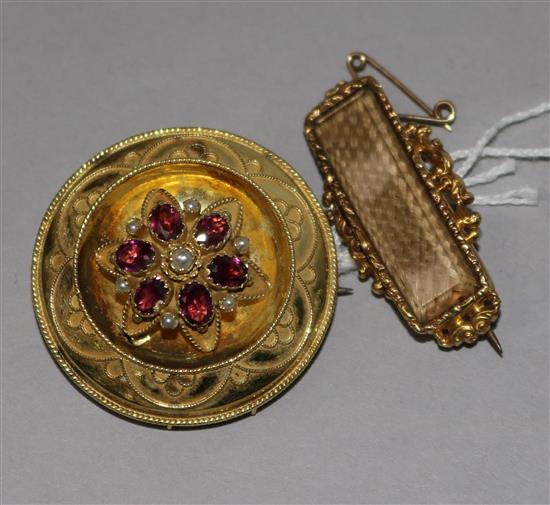 A 19th century gold, garnet and seed pearl set brooch and a gold mourning brooch with plaited hair.